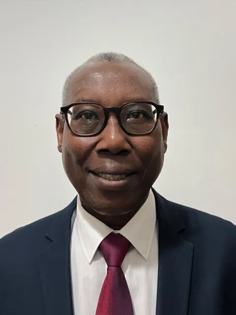 Joseph Mucumbusti from rwanda smiling for a portrait