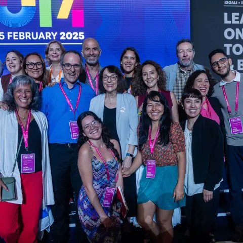 Global NCDA Forum delegates smiling on stage