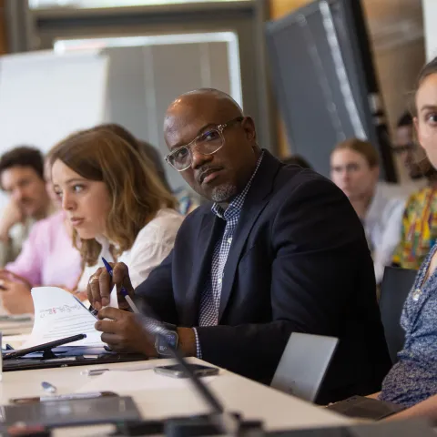 Man listening during an NCD advocacy meeting in geneva
