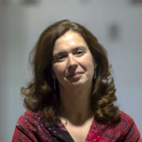 woman smiling at camera with red shirt on