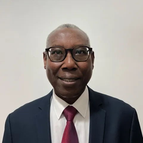 Joseph Mucumbusti from rwanda smiling for a portrait