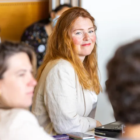 Smiling lady with red hair at NCD civil society event