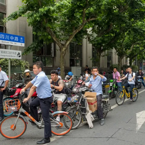 A group of cyclicts at a busy junction in Shanghai, China