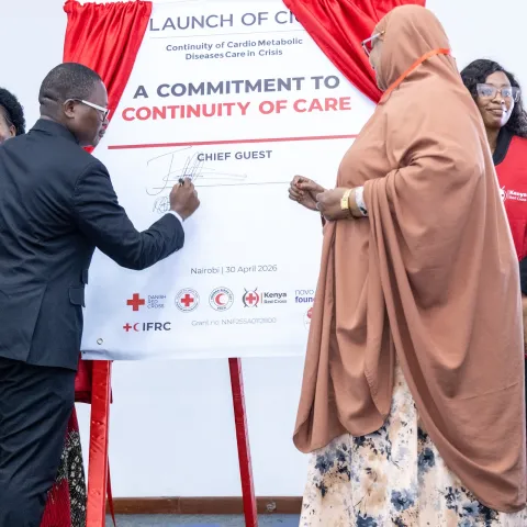 Politician signs "Commitment to continuity of care" banner in Kenya