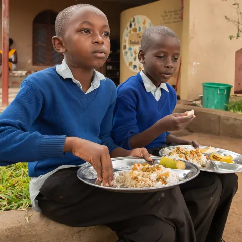 Children eating at a school in Tanzania