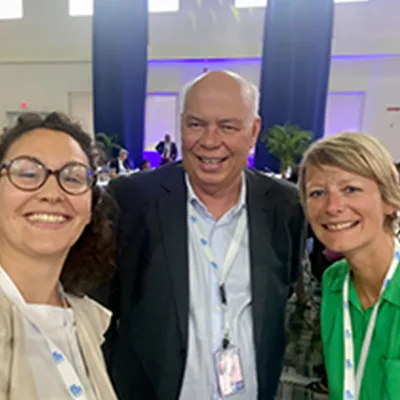 Three people smiling at camera during NCD advocacy event in Barbados