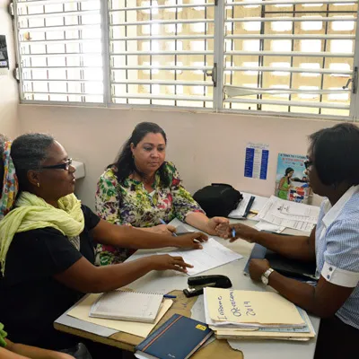 Nurse in caribbean with two women patients chatting