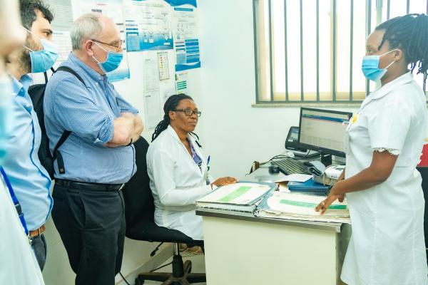 Nurses Rachel Nirere and Jeannette Maniraguha from Masaka District Hospital discuss Patient Navigation Initiative with Bo Norvving, NCDA Board Member and Past President of World Stroke Organiszation.